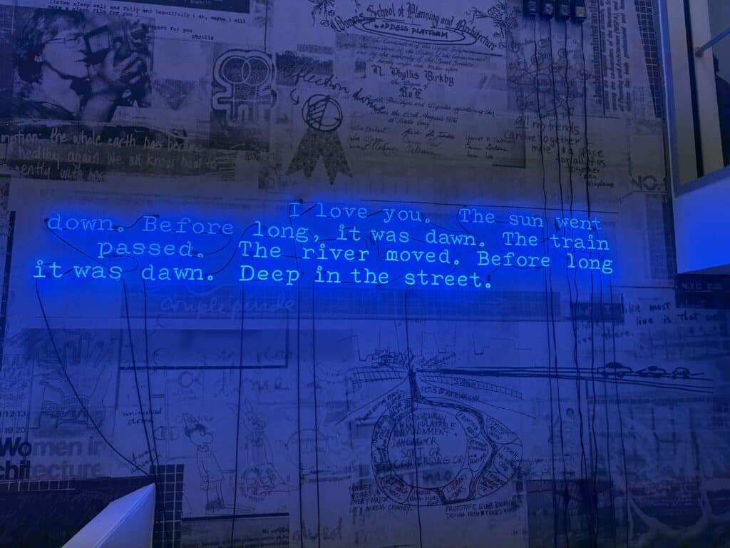 neon words on a collage wall